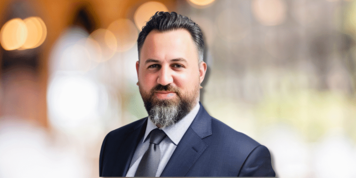 Tamir Leo Konortov, founder of KAL Solutions Group, in a suit, representing global tech outsourcing excellence.