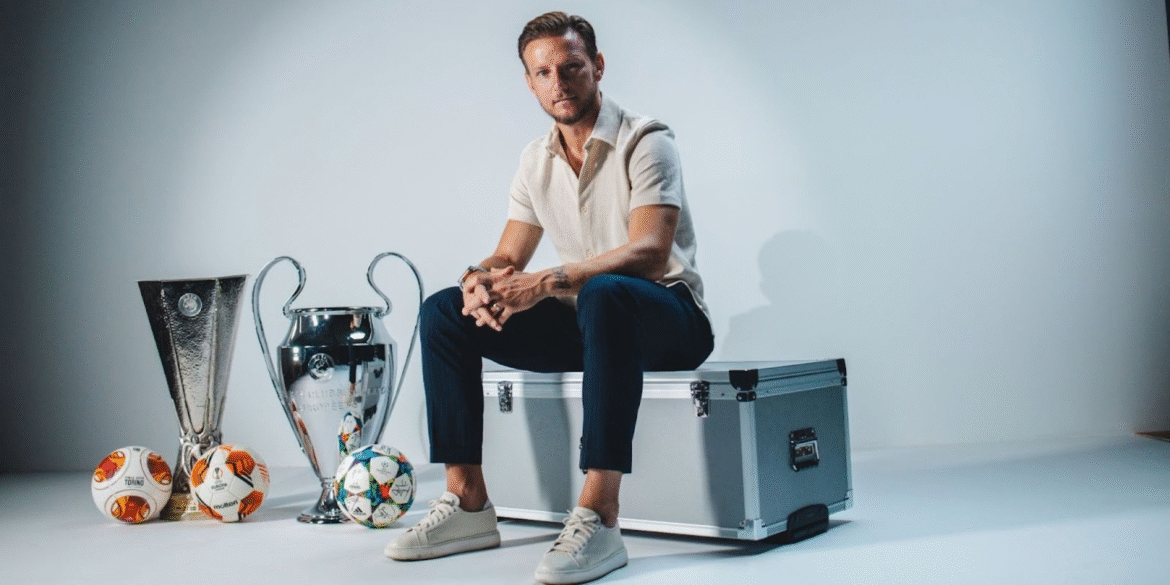 Footballer sits beside Champions League and Europa League trophies, representing EXCENSY Group’s legacy-driven athlete representation.