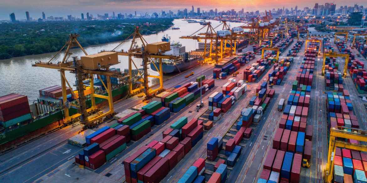 "Cargo containers and shipping cranes at a busy international port terminal during sunset, showcasing global trade, logistics, and maritime transportation infrastructure."