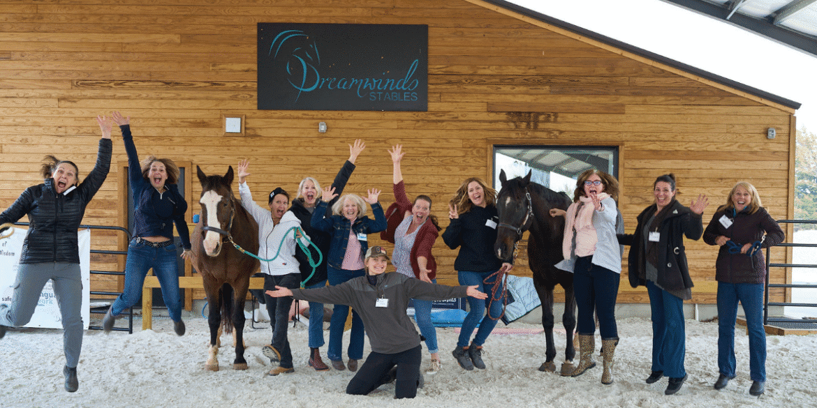 Tracey Evans, founder of Dreamwinds, guiding a corporate team through an equine-assisted leadership session, emphasizing communication, collaboration, and authentic leadership development.
