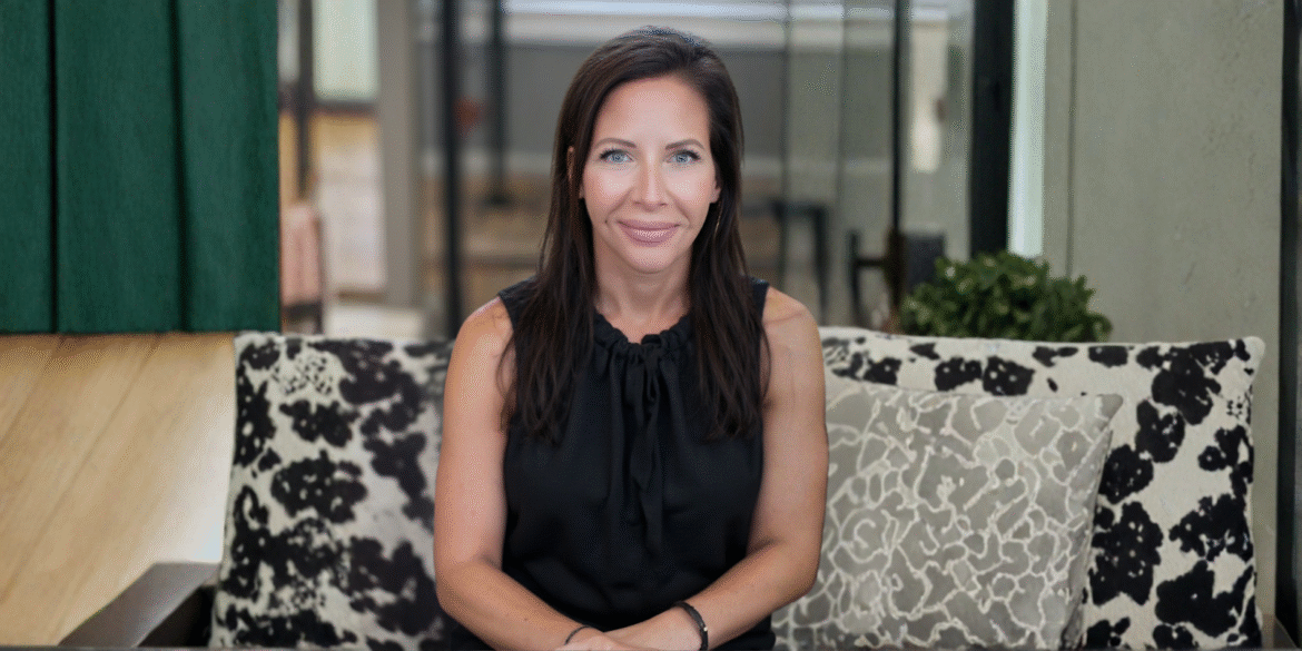 Laurie Groh, founder of Shoreside Therapies, sitting comfortably in a cozy, welcoming therapy space, embodying connection and warmth.
