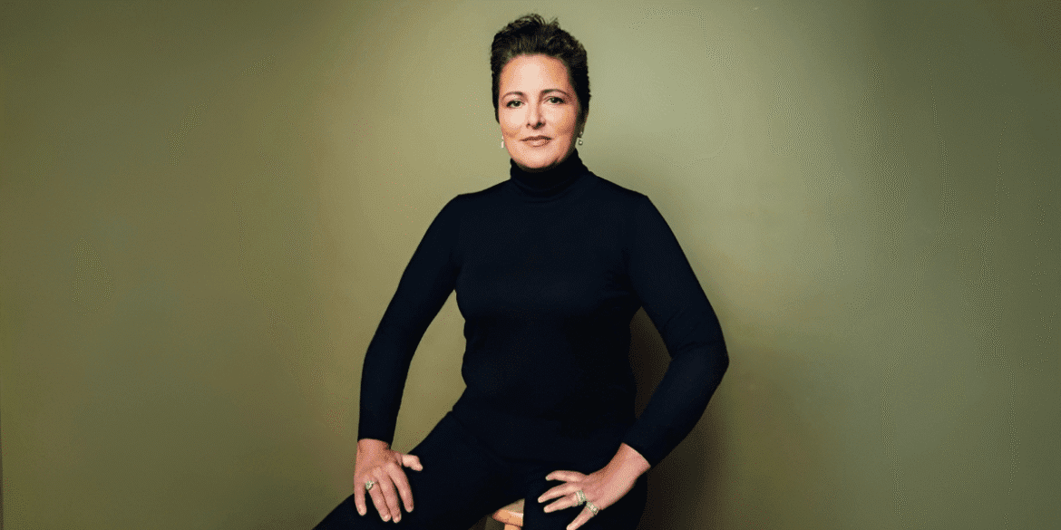A confident woman wearing a black turtleneck poses, embodying strength and transformation, reflecting Josselyne Herman-Saccio’s coaching philosophy.