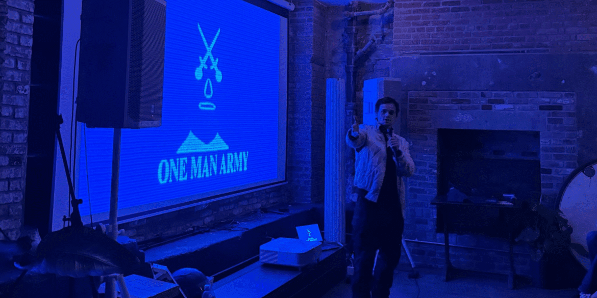 **Aaron Dalla Villa presenting One Man Army’s studio vision at a live screening and industry event.**