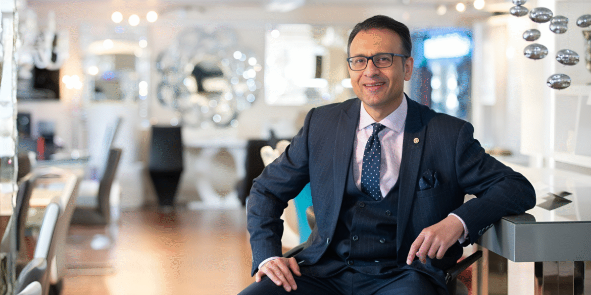 Asad Shamim, CEO of Furniture in Fashion, showcasing modern, affordable furniture in a stylish, customer-focused showroom environment.