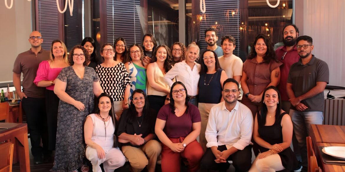 A joyful group of ENBER University faculty members posing for a photo in a restaurant, celebrating their top ranking in scientific production.