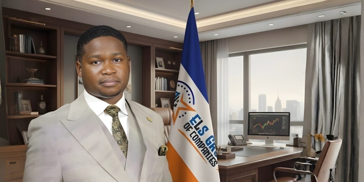 Simon El-Longwell, founder of ELS GROUP, standing confidently in his office with the company flag in the background.