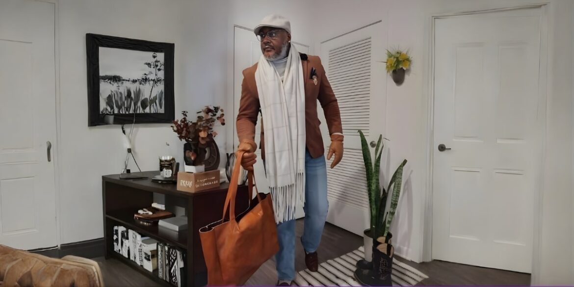 A well-dressed man walking out of a stylish home, carrying a leather tote, exuding confidence and personal style.