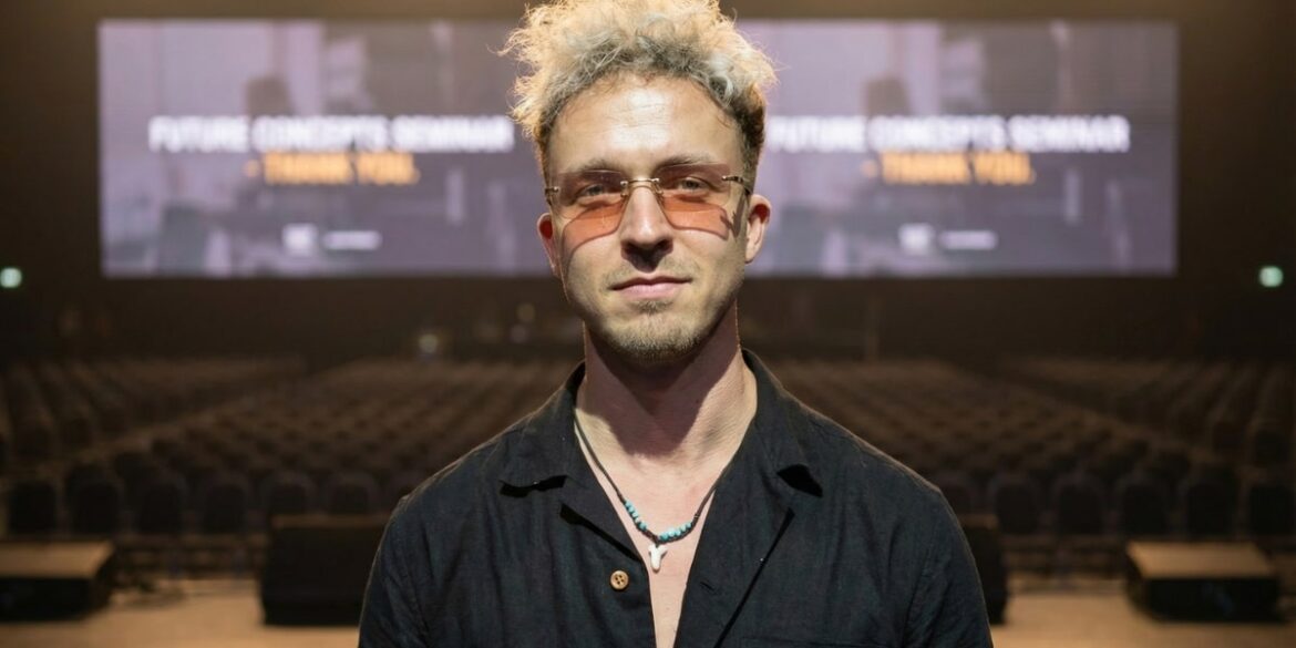 Yasin Borry, founder of BYAS and Vibe Agency, stands in front of an audience at a music event.