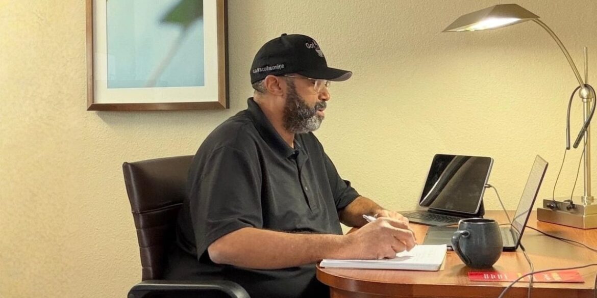 Ed Carter working at a hotel desk, managing Carter's Coffee Online with coffee, laptop, and handwritten notes.