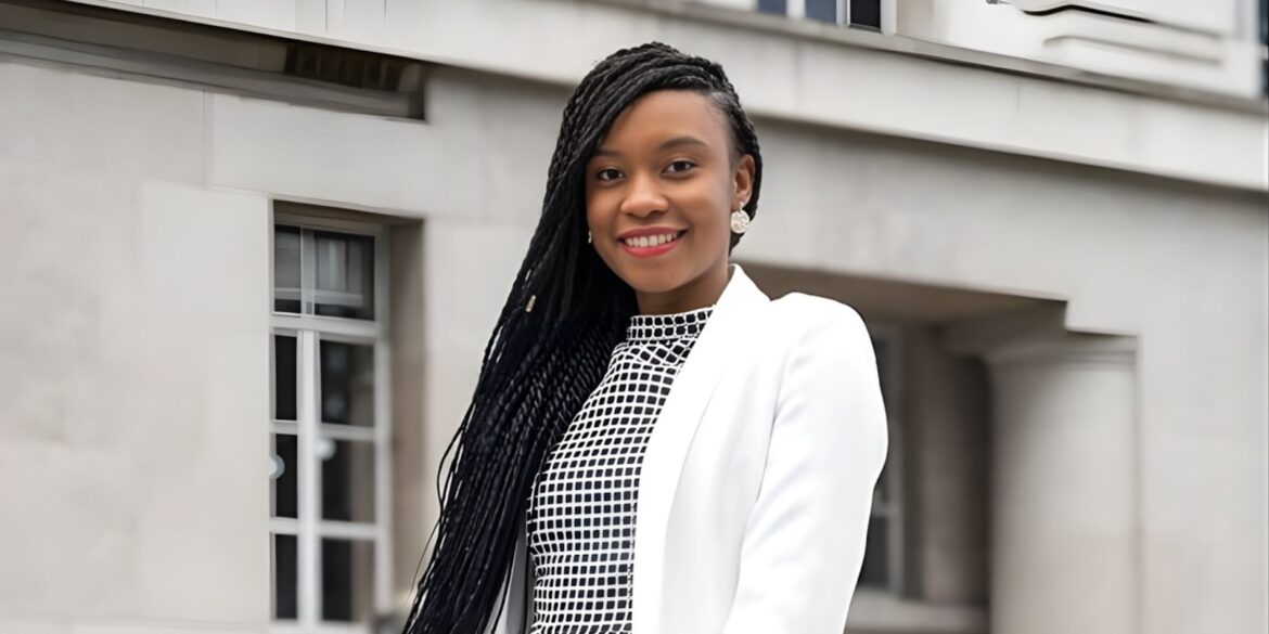 Dr. Amanda Mwale, founder of Resourced to Thrive, smiling confidently in a professional white blazer against a neutral background.