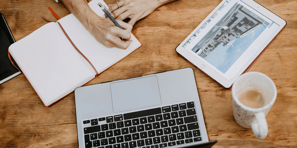 Person typing on a laptop, highlighting the need for clear branding and optimized digital content for trades.