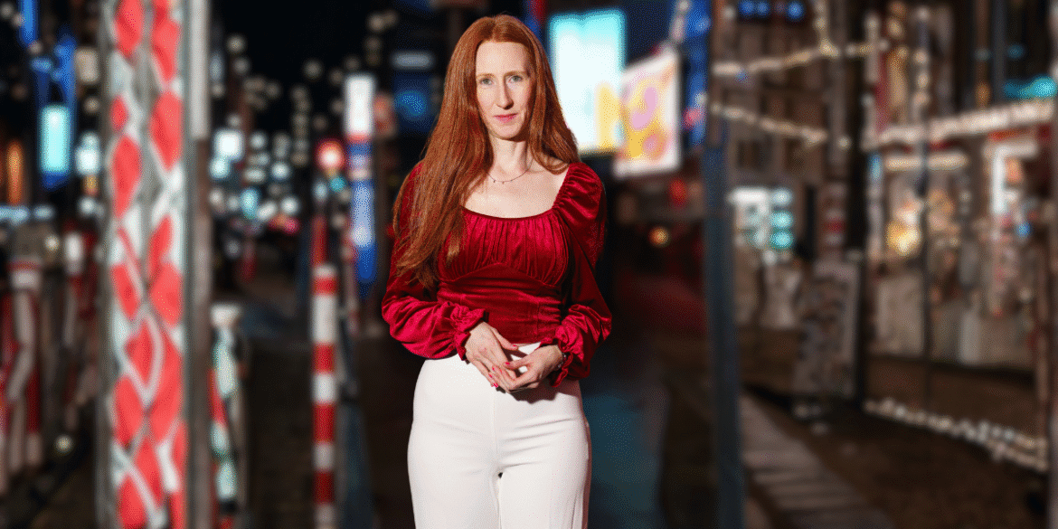 Monica Trombley, creative professional and entertainment lawyer, stands confidently in a vibrant city setting.