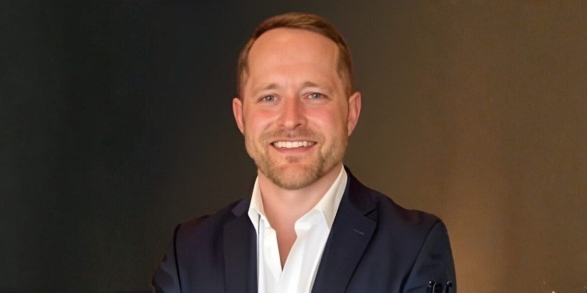 Garrath Robinson smiling confidently in a professional setting, embodying leadership in modern GTM execution and organizational alignment.