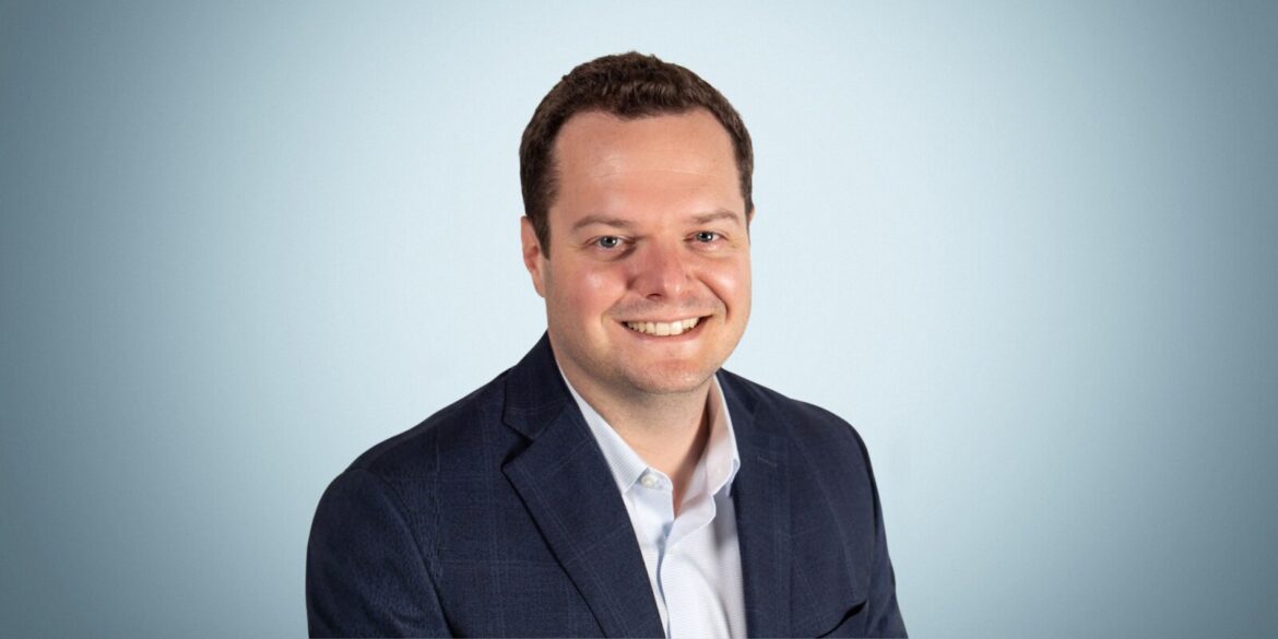 Amit Urban, Director at BellStreet San Jose, smiling confidently in a business suit, embodying trust and expertise.