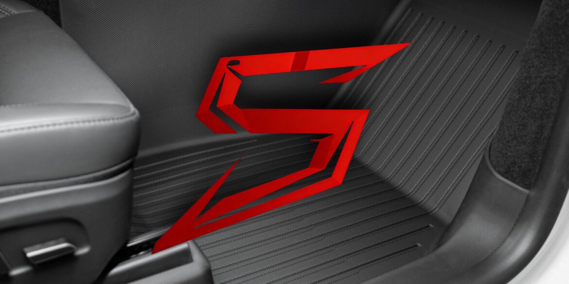 A close-up of a vehicle interior with a red "S" logo on the floor mat, symbolizing CabinProtect™.