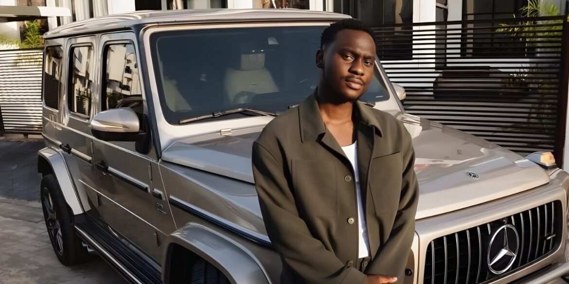 A young entrepreneur, Lucky Mane, standing confidently in front of a Mercedes G-Wagon, representing his success in business.