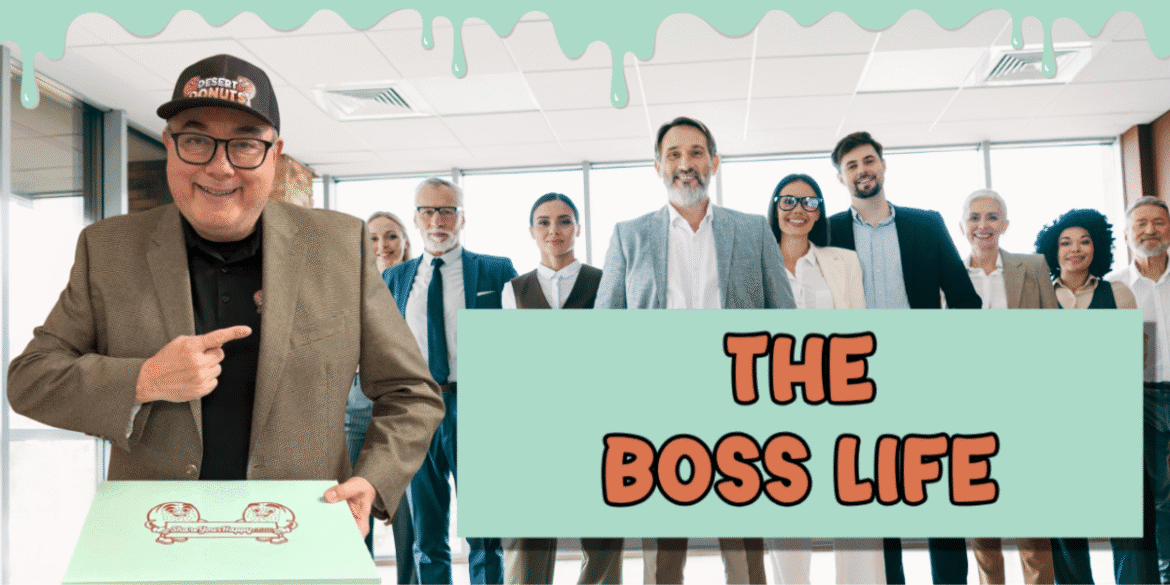 Michael Gallegos with a box of Desert Donuts, standing with colleagues in a professional office setting.