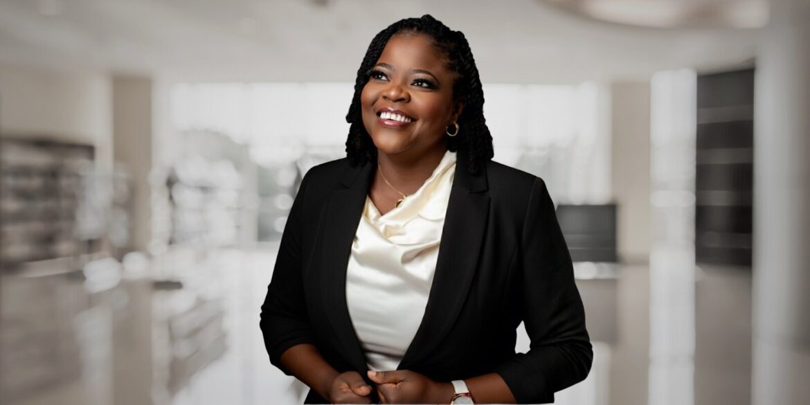 A smiling woman in a business suit, representing innovation in creative technology and entrepreneurship.
