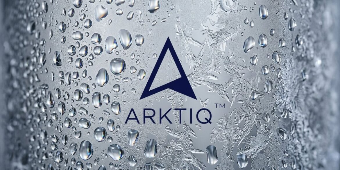 Close-up of the Arktiq Vodka logo on a frosted, condensation-covered surface emphasizing ice-cold purity.