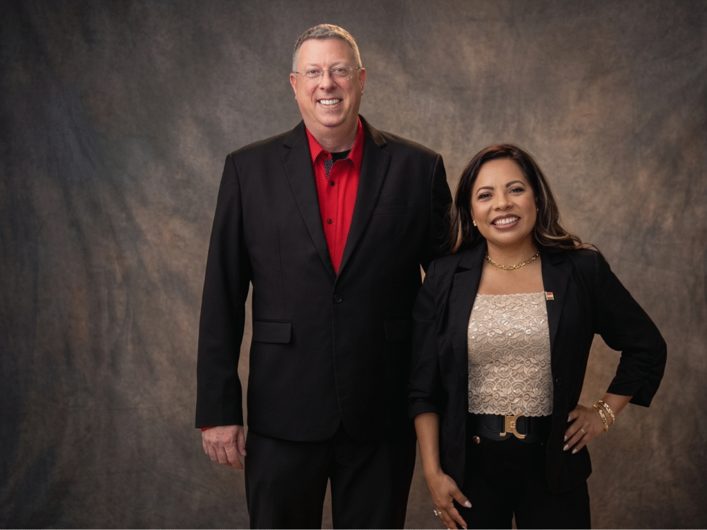 Chris and Dr. Maricela Soberanes posing together in business attire.