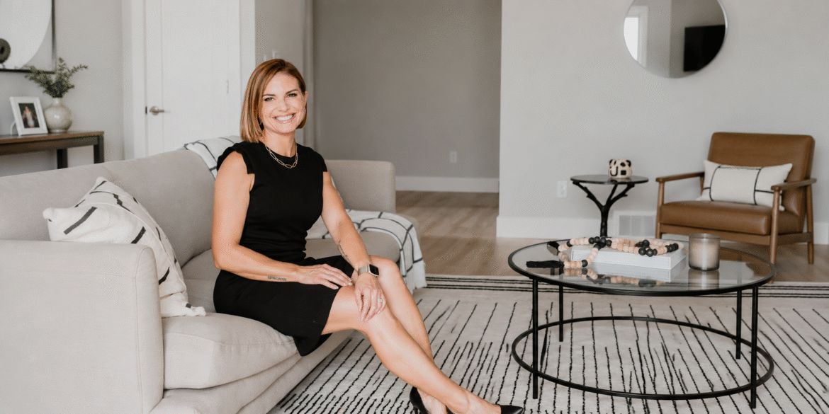 Angela Porrelli seated in a staged living room during a real estate consultation.